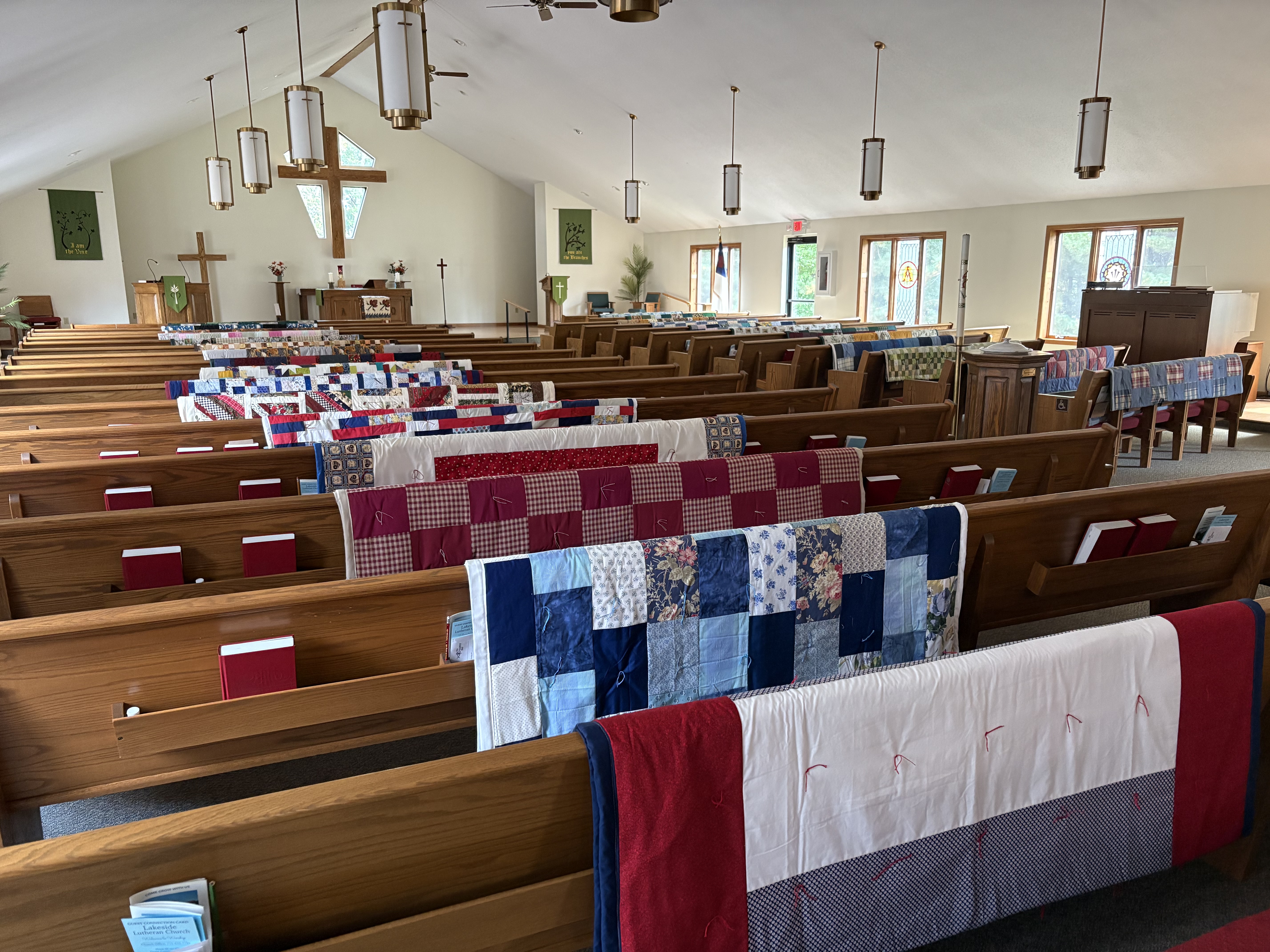 quilts on the back of pews